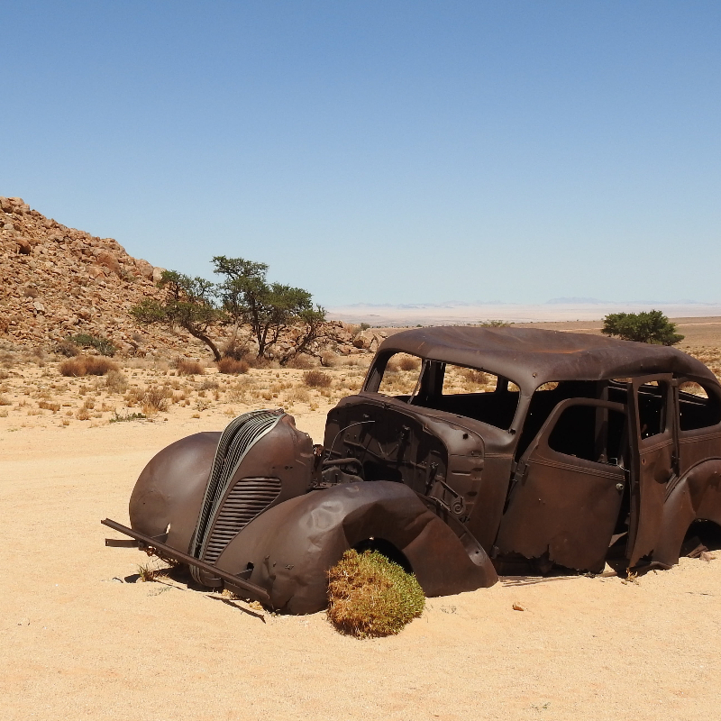 Abandoned brown vintage car on desert