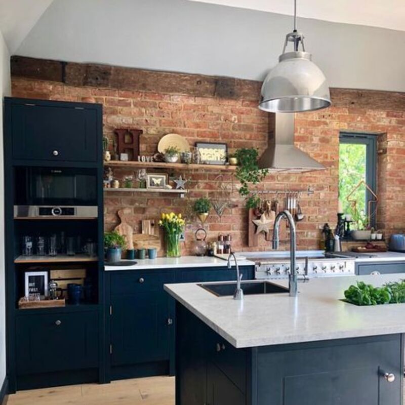 Blue kitchen with bricks